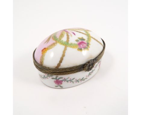 A Continental oval trinket box, with domed rising lid, decorated with garlands and ribbons of flowers, crossed swords mark to