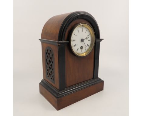 A mahogany cased mantel clock, the drum movement with white enamel dial and single winding hole, the domed top case with ebon