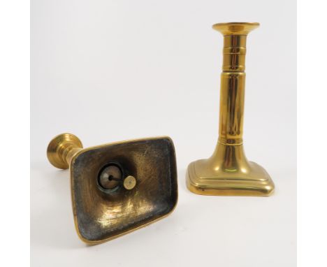 A pair of brass candlesticks, raised on rectangular bases, height 7.5ins, together with a brass pestle and mortar and a coppe