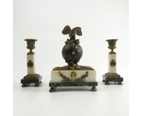 A French clock garniture, the ball movement with eagle finial, mounted on a gilt metal wave, the two colour marble base mount