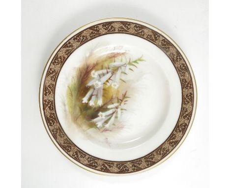 A Royal Worcester side plate, decorated with white Australian flowers by R Austin, to a printed brown border, dated 1929, dia