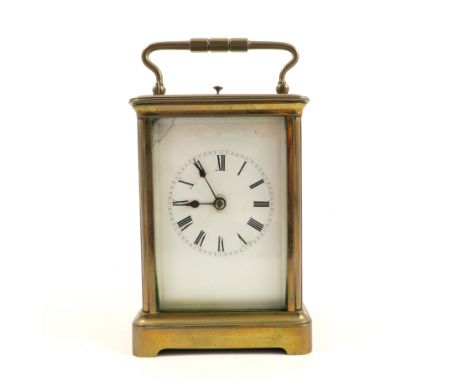 A brass cased repeating carriage clock, with white enamel dial and Roman numerals, height including handle 7ins    Condition 