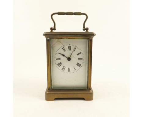 A brass cased carriage clock, with white enamel dial and Roman numerals, stamped France to the movement, af, height 5.5ins 