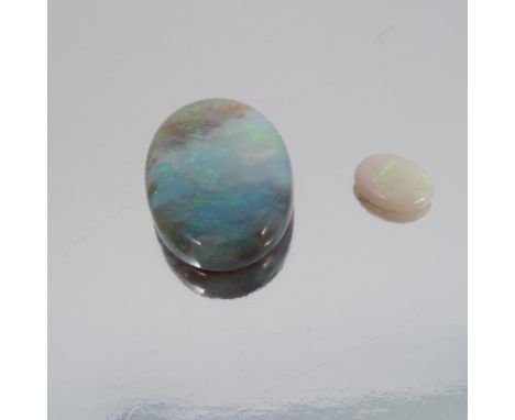 A loose opal cabochon, of shallow oval shape, measuring approximately 20.1mm by 14.1mm by 5.3mm deep, with a small opal caboc