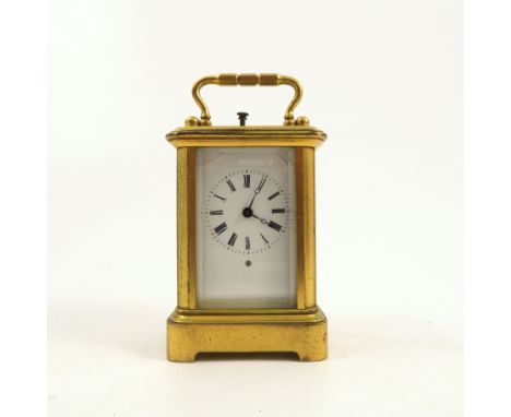 A miniature brass cased repeating carriage clock, with white enamel dial and Roman numerals, height including handle 3.75ins 