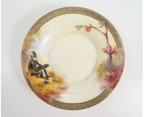 A Royal Worcester saucer, decorated with a seated Aborgine using a stick to create fire, and a tree, with embossed surface, b