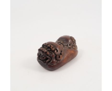 A Chinese carved wooden netsuke, carved with two masks of dogs of fo, height 2.5ins