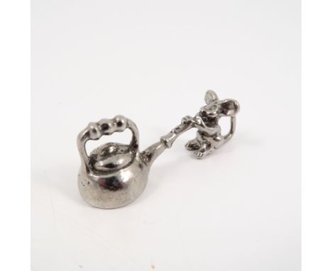 A small metal trinket, of a mouse and a kettle 