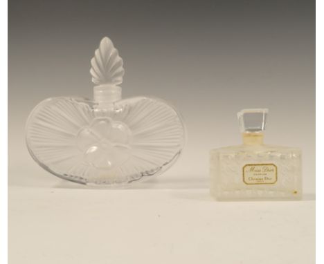 A Lalique glass perfume bottle, the base of heart form with moulded flower head to the centre, having an anthemion shape stop