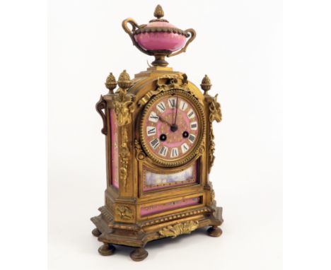 A 19th century gilt metal mantel clock, the striking movement stamped H P & Co. with pink porcelain dial, the case inset with