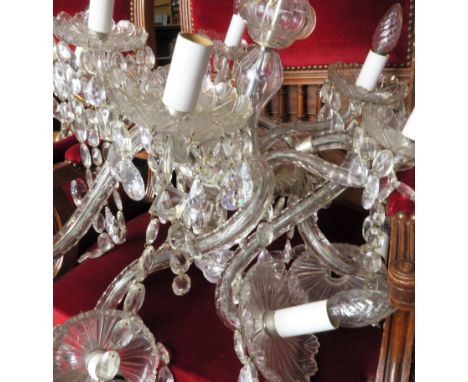 A glass chandelier, with eight lights, with scroll arms and glass lustre droppers