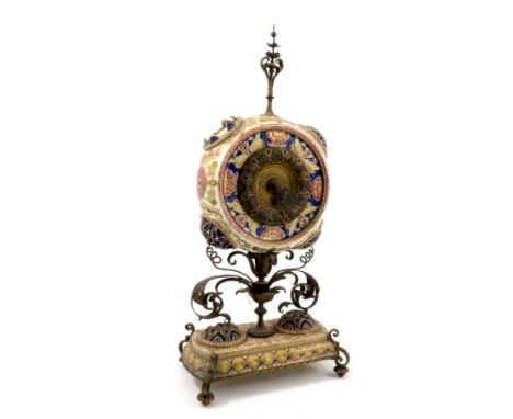A porcelain and gilt metal mantel clock, the drum movement with gilt dial, set in a porcelain circular case decorated with fl