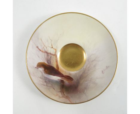 A Royal Worcester saucer, decorated with an Australian bird on a branch by R Austin, dated 1929, diameter 4ins