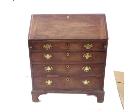 A Georgian mahogany bureau, fitted with a central drawer flanked by pigeonholes and step drawers, fitted with four graduated 