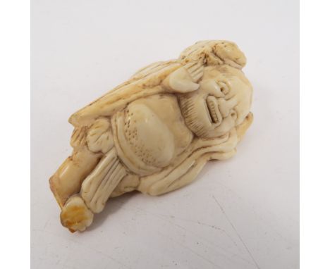 A 19th century carved ivory netsuke, carved as a male figure, height 2.5ins