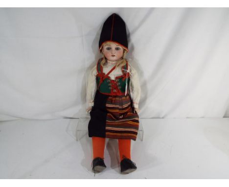 Kling - a Kling bisque headed dressed doll with sleeping blue eyes, open mouth, ceramic teeth, with bisque hands, wearing a G