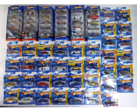 Hot Wheels - in excess of sixty diecast vehicles to include six five-car packs and some 2007 First Edition models, items m in