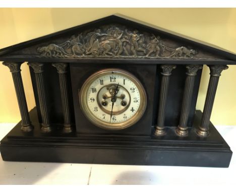 A Victorian slate mantle clock of classical influence with Arabic numerals, visible escapement and Corinthian columns. Measur