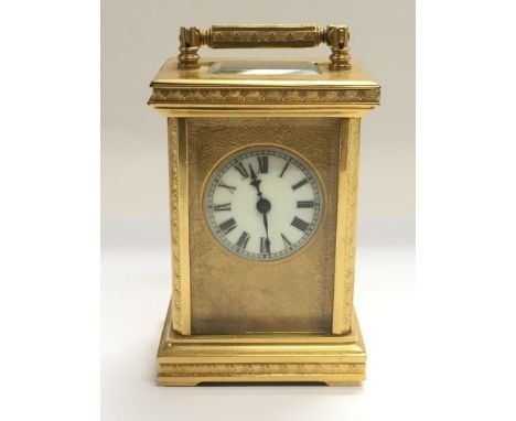 A brass cased carriage clock with key.