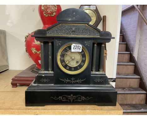 A Victorian slate mantle clock with inset copper panel.