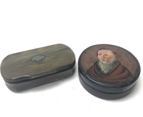 An antique horn snuff box with a cartouche on the lid, and an antique papier-mÃ¢chÃ© snuff box with a painted lid, depicting 