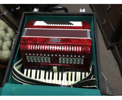A cased studio accordion  .