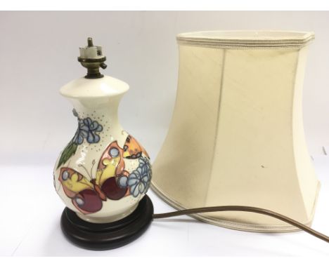 A Moorcroft table lamp decorated with butterflies.