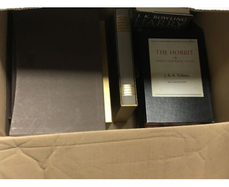 A box containing books three first edition Harry Potter books The HobbitsOn and back again by JRR Tolkien and other Folio soc