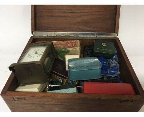 A box containing vintage Dinky trains a carriage clock coins and other oddments (a lot)