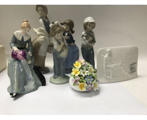 A collection of ceramics including four Nao figures and a Doulton figure .
