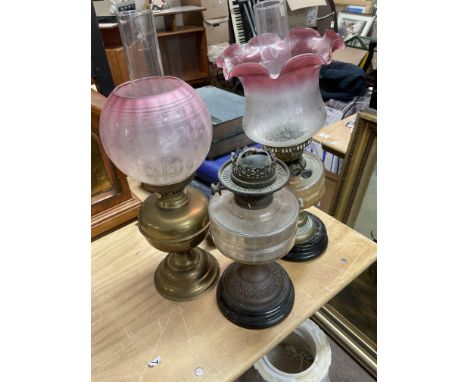 4 Victorian oil lamp bases and cranberry shades.