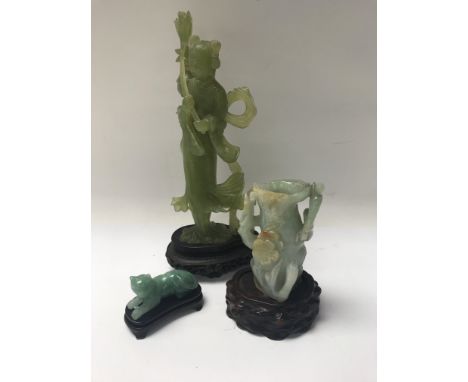 A collection of three jade type carving comprising figure vase and cat .
