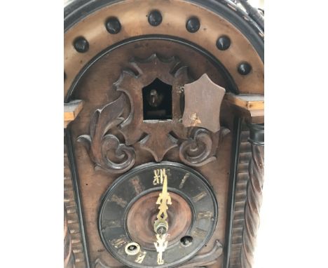 A walnut case cuckoo clock