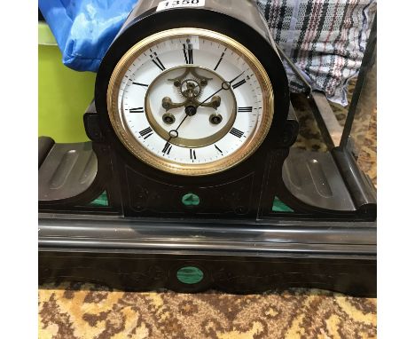 A slate mantle clock with Roman numerals and visible escapement inlaid with green marble - NO RESERVE