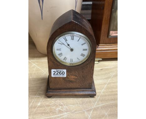 A small oak inlaid mantle clock