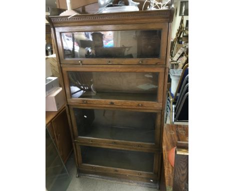 An oak four tier Lebus bookcase, approx 170cm x 88cm x 36cm.