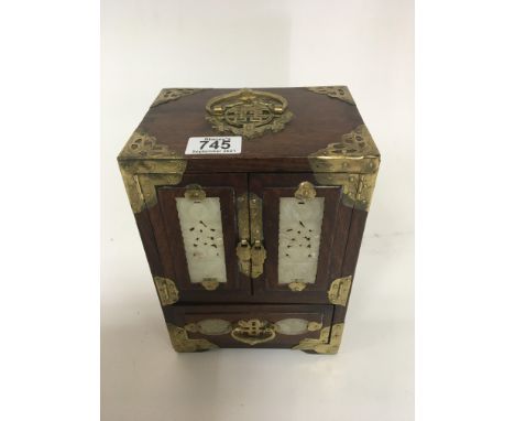 A Chinese hardwood jewellery box with carved jade type inset panels and brass mounts good condition