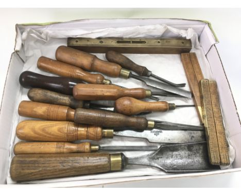 A collection of vintage tools comprising chisels and boxwood rules etc.