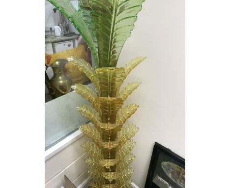 A glass standard lamp in the form of a palm tree .