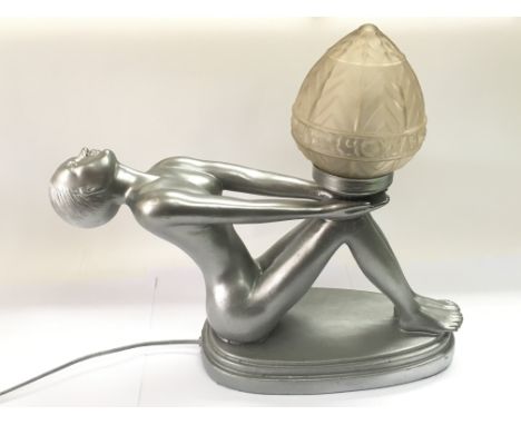 An Art Deco style table lamp in the form of a nude female figure holding a lamp in her hands, approx height 41cm.