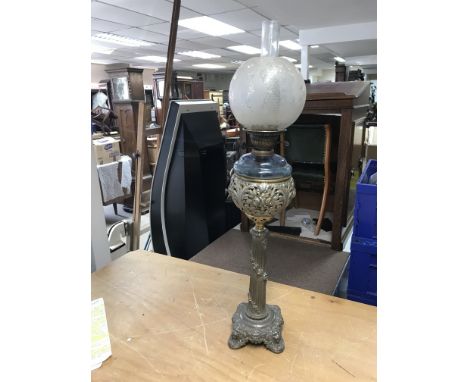 A tall Victorian oil lamp on column support decorated with garlands etc. This has a blue glass reservoir and etched shade. Me