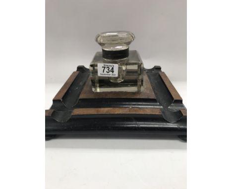 A large glass inkwell with stand .