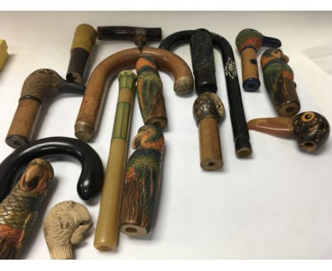 A Collection of novelty walking stick / umbrella handles .