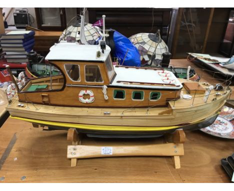 A wooden model of a British cruiser, fitted with an electric motor.