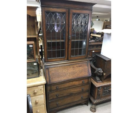 An oak bureau bookcase with lead light doors above a fall front with drawers under - NO RESERVE