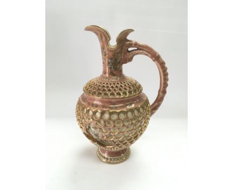 A Zsolnay pierced jug with giltwork floral decoration on a pink ground, approx height 22cm.