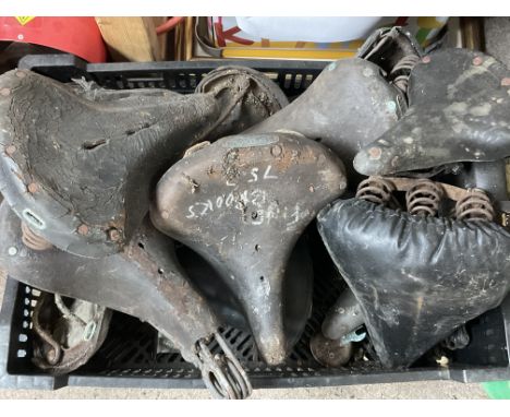 A box of vintage leather bicycle seats etc. Inc Brooks.