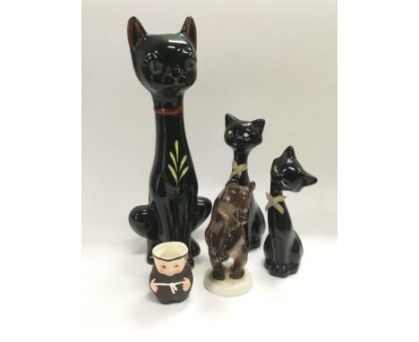 Three ceramic figures of cats, Lomonosov bear and a Goebel monk (5).