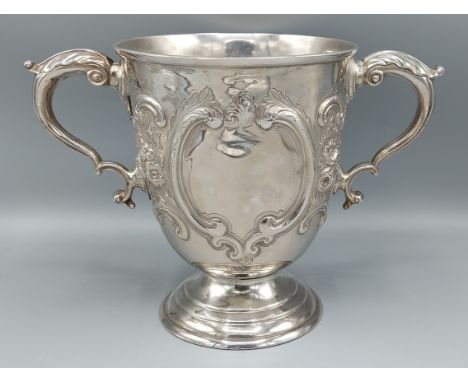 A Victorian silver twin handled pedestal trophy cup with embossed decoration, London 1877 makers Lambert &amp; Co, 18cms high