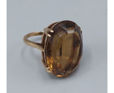A 9ct gold ring set with a large oval Citrine with pierced mount, 7.9gms, ring size I